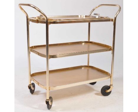 A retro vintage mid 20th century circa 1950's butlers hostess serving cocktail trolley having a three tier of textured metal 