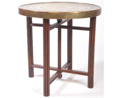 A vintage 20th Century Indian / Middle Eastern brass topped Binares occasional table having engraved and repousse patterned d
