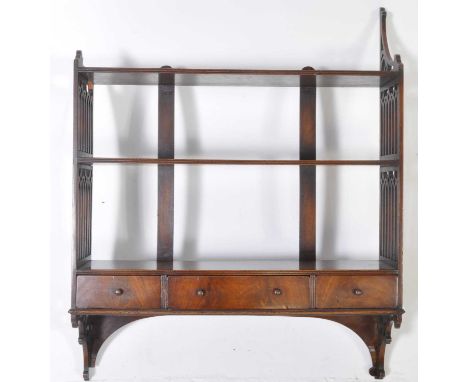 A 19th century George III mahogany wall shelf whatnot. Having a series of shelves with three parallel drawers to underside. W