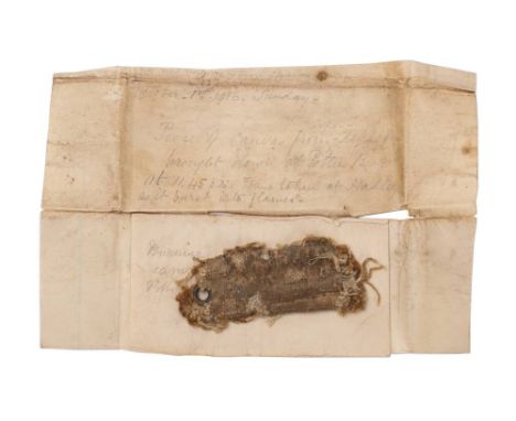 Of WWI Interest. A section of burnt Zeppelin canvas from L-31: contained within a section of folded paper with manuscript 'Oc