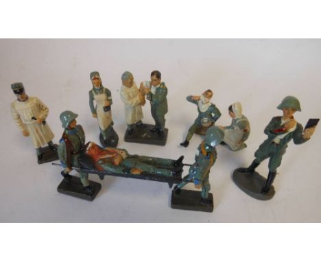 Lineol and Elastolin, a group of medical staff and wounded: includes stretcher bearers, doctors, nurses, figures shaving (9)