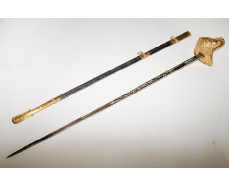 A George V RAF Officers sword, the straight single edged blade with acid etched decoration, over a gilt brass pierced guard d