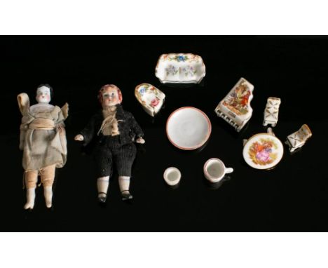 Two late 19th Century German Bisque doll house dolls and small group of porcelain cups and miniature furniture.: