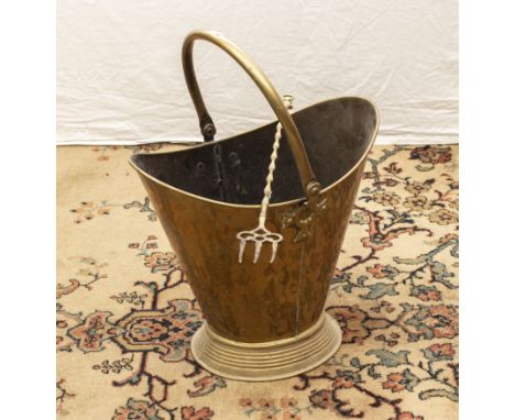 A copper coal bucket and toasting fork