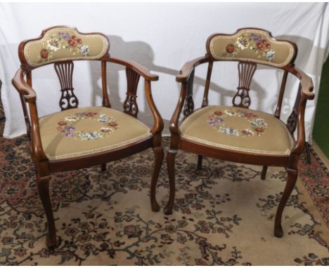 A pair of mahogany arm chairs with tapestry seats and back