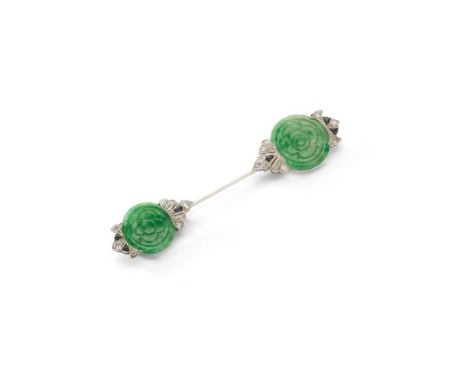 An Art Deco jade, diamond and onyx jabot pin, circa 1925 Each terminal set with a circular carved jade plaque, with old brill