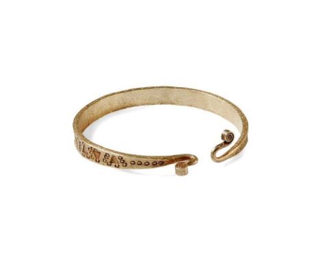 A Viking gold bangle, early 2nd millennium A.D.  Formed of solid gold, the exterior stamped with alternating bands of circula