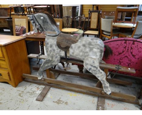 A vintage mottled grey rocking horse on wooden stand Condition reports provided on request by email for this auction otherwis