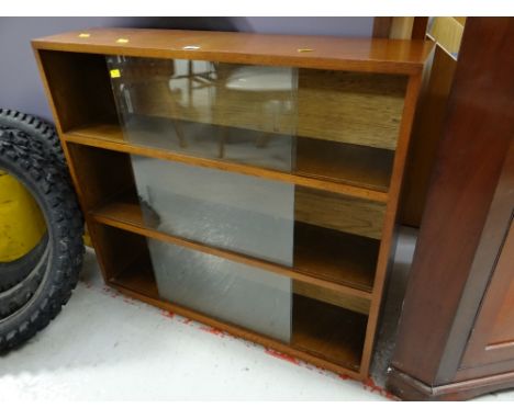 A vintage three-tier sliding door bookcase Condition reports provided on request by email for this auction otherwise items pu