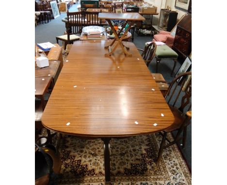 A reproduction George III style mahogany two pedestal dining table, with single leaf insert, together with a reproduction min