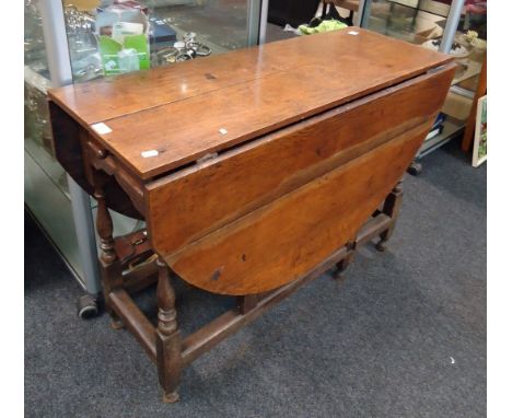 A part 18th century oak gateleg dining table, the later top over a single drawer on baluster and bobbin turned supports, 71 x