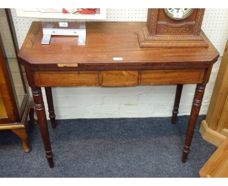 A George III mahogany and ebony strung card table, the rectangular canted top folding to a double gate on ring turned taperin