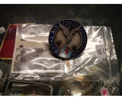 A chrome and enamel Royal Air Forces Association car badge, a signed RAF notepaper by Leslie Howard, and two WWII period phot