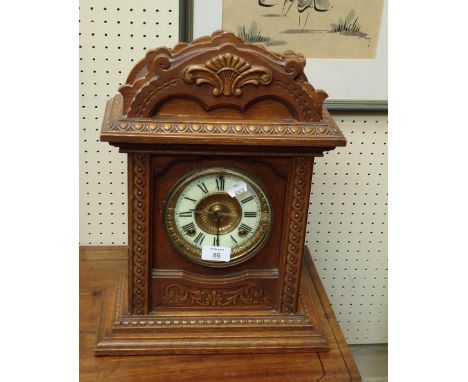 An early 20th century Ansonia 8 day mantel clock, with carved oak architectural case, together with a collection of 19th/20th