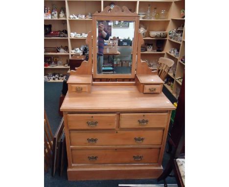 An Edwardian satinwood dressing chest, with bevelled mirror over two trinket drawers, and four further drawers, on plinth