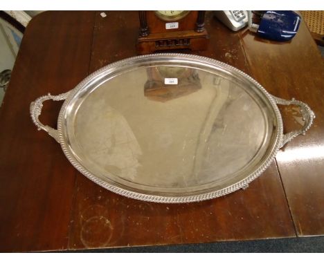 A very large silver plated two handled oval tray, bearing a presentation inscription to Colonel H J Grassett, CMG, on his ret