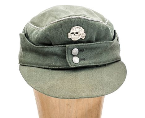 A scarce Third Reich officer’s Waffen SS peaked field cap, field grey light summer weight material, with silver braid crown p