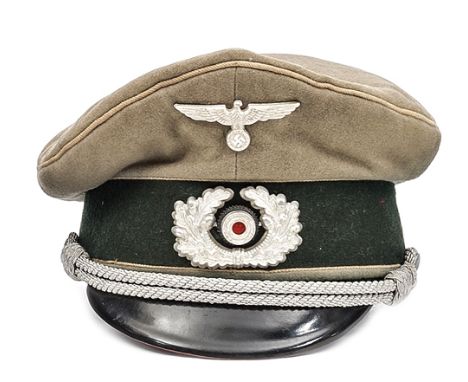 A Third Reich infantry officer’s peaked cap, light field grey crown, white piping, black “Ersatz” sweat band. GC (a little wo