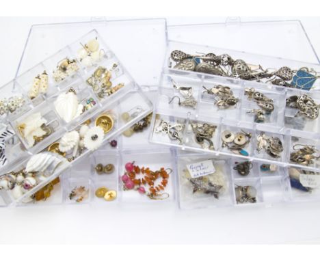 A large collection of vintage and modern earrings, in a vast selection of styles and materials, some silver examples, present