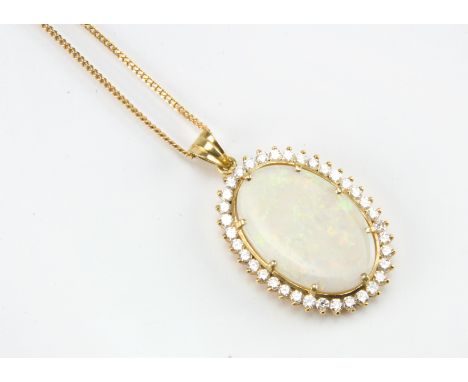 A modern 18ct gold opal and diamond pendant, the 3cm oval opal within brilliant cut surround, some natural cracking to opal, 