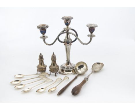 A collection of silver and silver plate, including a pair of silver cruets, a silver serving spoon with wooden handle, severa