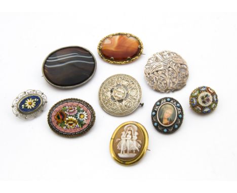 A collection of nine Victorian and later brooches, including an oval agate in silver frame, a hardstone example, a cameo of t