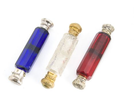 Three Victorian and later cut glass scent bottles, each double ended, one blue and one ruby example, possibly with silver mou