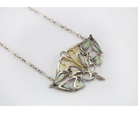 An Art Nouveau style white metal and enamel pendant, having pierced lily of the valley and a glass panel supported on a chain