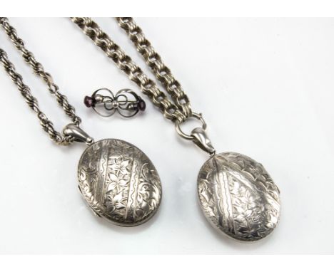 A pair of Victorian silver locket pendants, one on rope twist chain, the other on heavy circular link necklace, together with