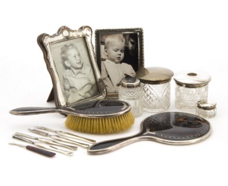 A collection of Victorian and later silver and other dressing table items, including two photograph frames, a silver and tort