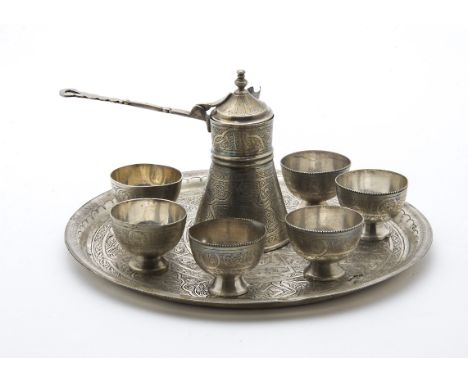 A vintage Egyptian silver tea set, comprising circular tray, six bowls and teapot of small form having engraved decoration, s