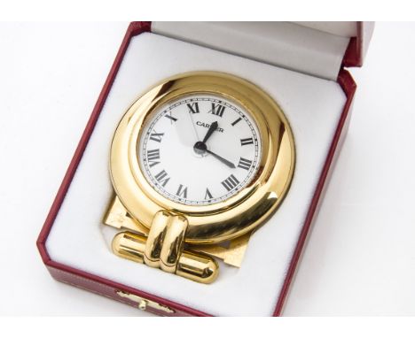 A Must De Cartier Colisee travel alarm clock, the gilt timepiece presented in a red and gilt box with guarantee (3)not workin