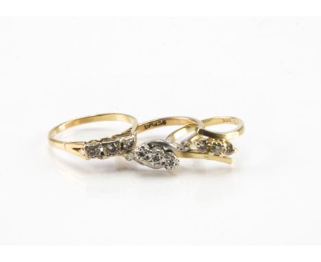 Three Art Deco and later gold and diamond rings, a 9ct and a 14ct crossover style three stone ring and another an 18ct three 