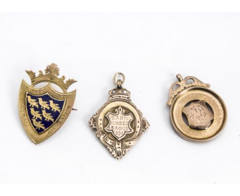 Three early 20th Century 9ct gold football medals and other items, one enamelled example for Sussex County Football Associati