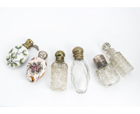 A group of six Victorian and later scent bottles, one porcelain example with hand painted designs, another porcelain with tra