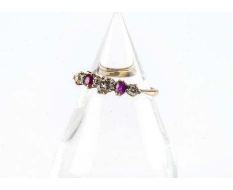 An Edwardian five stone ruby and diamond ring, set in platinum claws on an 18ct gold band, 2g and size L 