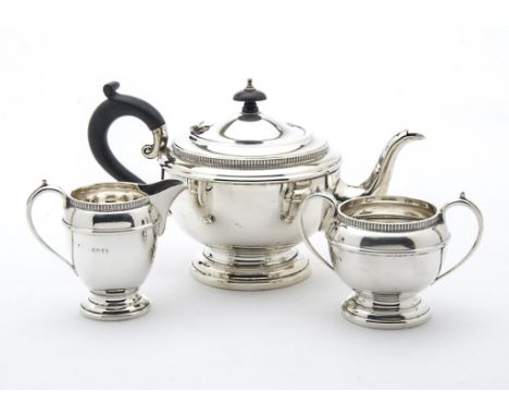 An Art Deco period silver three piece tea set by RWB, squat form with ear shaped handles, Birmingham 1938, 20 ozt (3) 