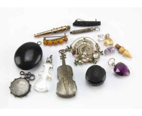 An Art Deco five bead amber brooch, together with a novelty retractable pencil in the form of a canon, a jet locket pendant, 