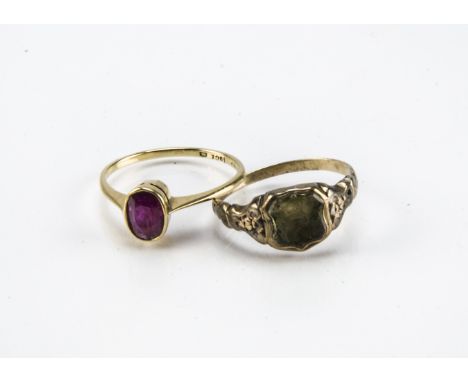 An early 20th century 18ct gold and ruby solitaire ring, 2g, together with a Victorian gold and citrine signet ring with fami