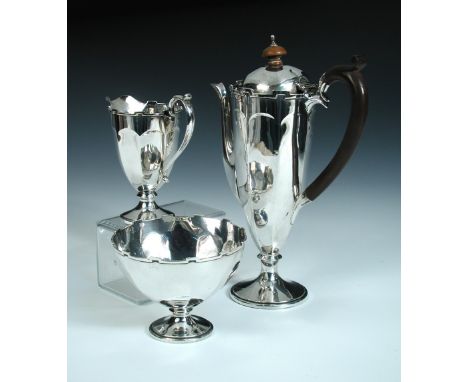 A silver three piece coffee set, by the Adie Brothers, Birmingham 1925, comprising:- a coffee pot of tapering octagonal shape
