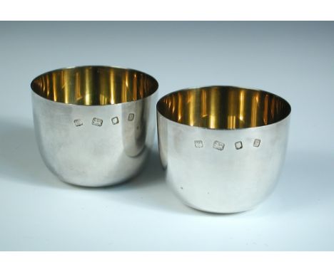 A pair of modern silver tumbler cups, by D & J Welby, London 1958, of plain form, the interiors gilded, uninscribed, 6.25cm h