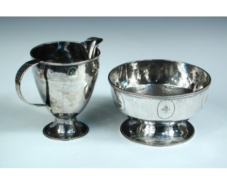 A small hand raised white metal sugar basin, unmarked, with beaded edges to the rim and the pedestal foot, 12cm diameter toge