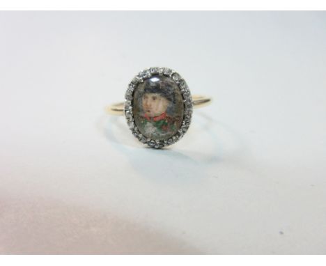 A Napoleonic portrait ring with diamonds circa 1800, the oval glazed panel portrait, believed to be of Napoleon, facing three