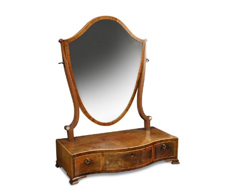 A Sheraton mahogany dressing table mirror, with a shield shaped mirror, on a serpentine base with three small drawers, on oge