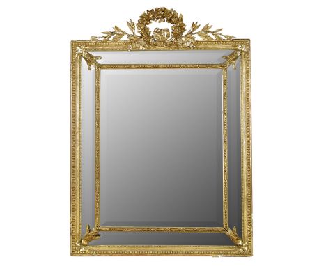 A 19th century gilt framed mirror, circa 1860, with gesso moulded wreath and laurel cresting, marginal plates, with moulded b