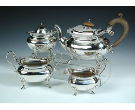 A silver three piece tea set, by The Goldsmiths' & Silversmiths' Company, London 1917, comprising:- a tea pot of compressed r