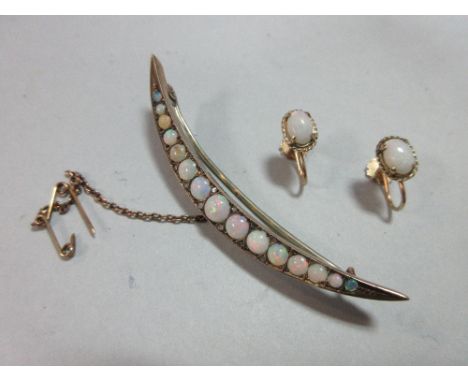 An Edwardian opal and diamond crescent brooch together with a pair of opal earrings, the open crescent brooch set with a grad