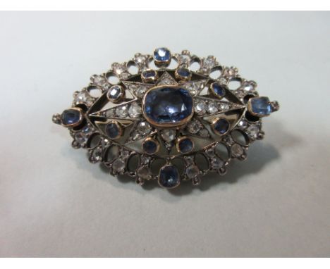 An antique sapphire and diamond brooch, of pierced navette design with a central rectangular cushion cut light blue sapphire 