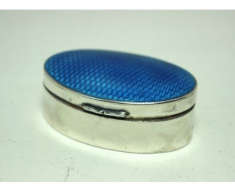 A small silver snuff box, by H Matthews, Birmingham 1910, of plain oval shape with blue bassetaille enamel cover, 5.5cm diame