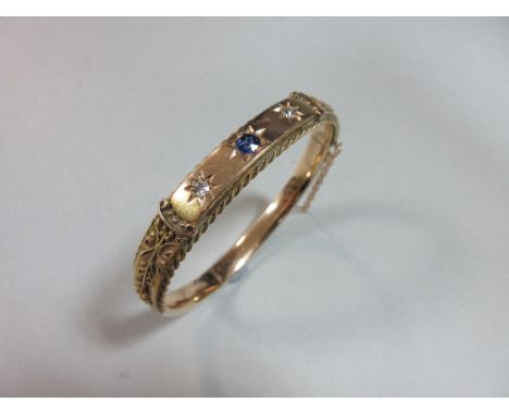 A Victorian 15ct gold sapphire and diamond hinged bangle, the front with extensive wire, bead and ropetwist decoration around